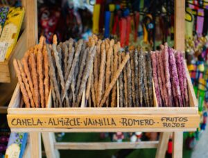 Vibrant display of assorted incense sticks with various scents in a wooden box.